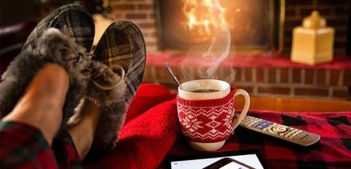 cosy living room with a fireplace and mug of steaming hot coffee