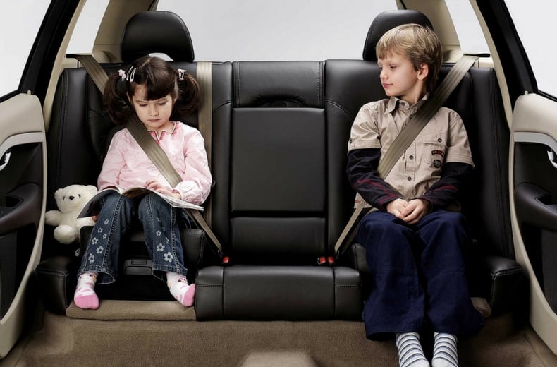 How old does a child have to be to sit in the front seat of a car in the U.K.?