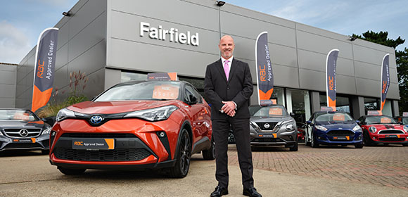 a car showroom with a suited man