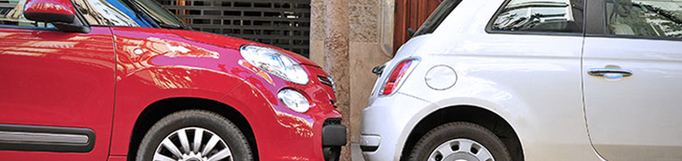 Two cars parked closely together
