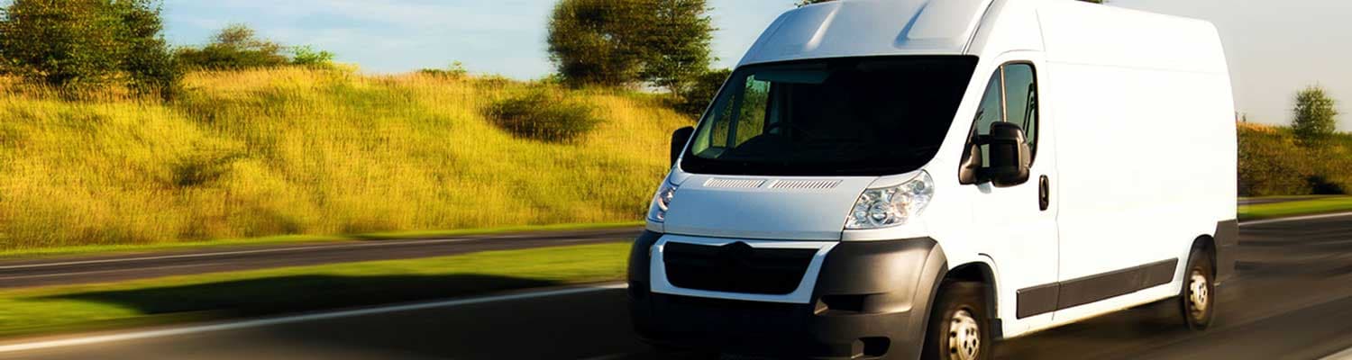 Van driving down road with motion blur