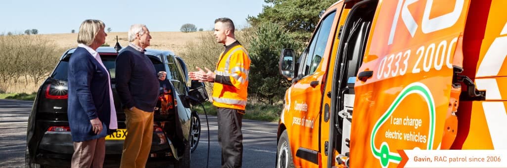 RAC patrol talking to an older couple on the side of the road