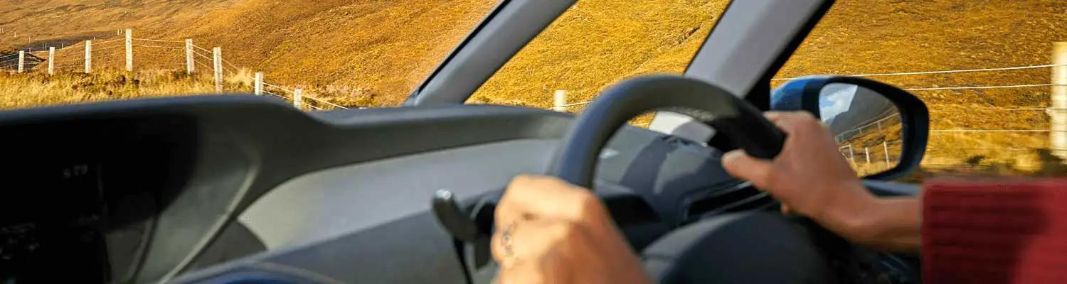 Close up on someone side inside a car