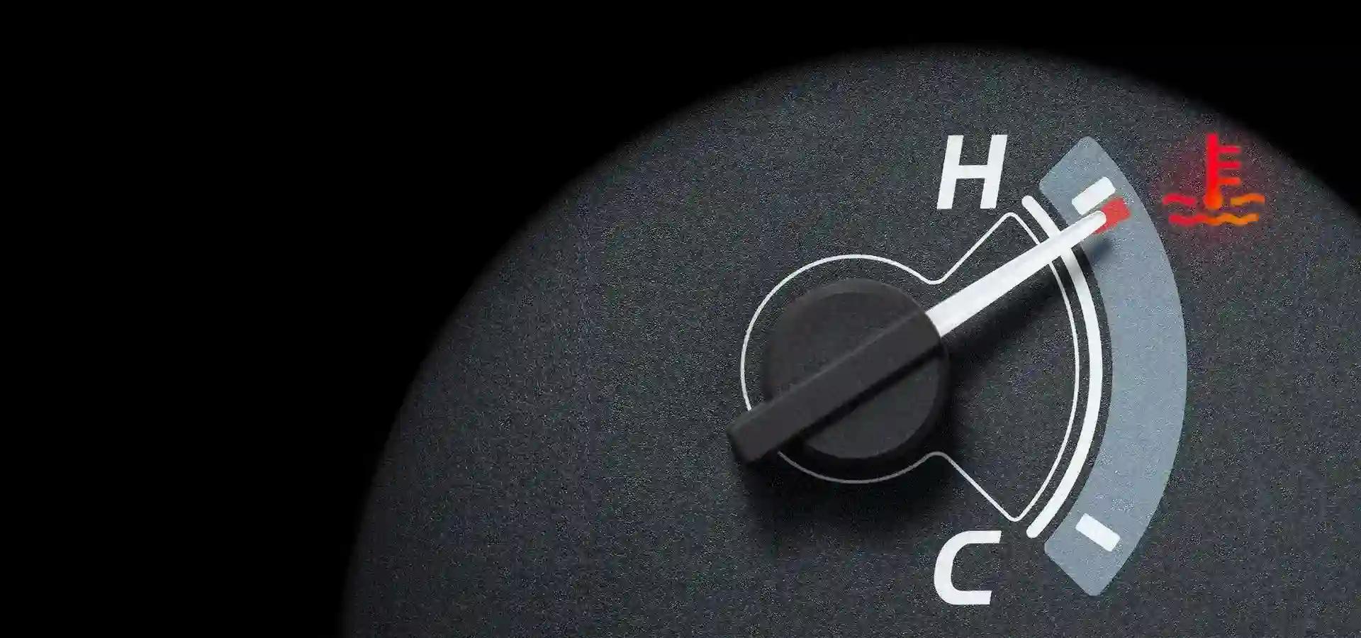 Close up of a car dashboard showing an enginer temperature gauge