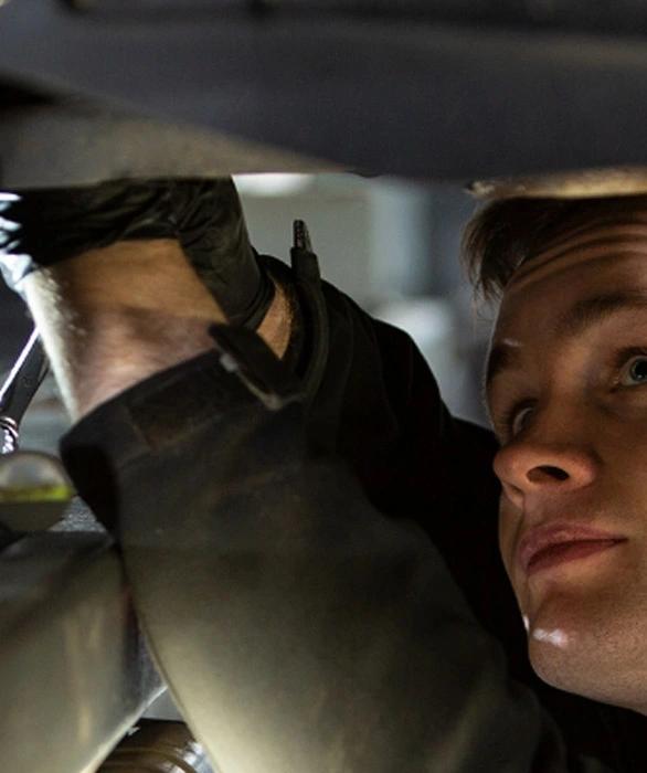Mechanic working beneath a car