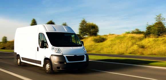 Van driving down a road with motion blur