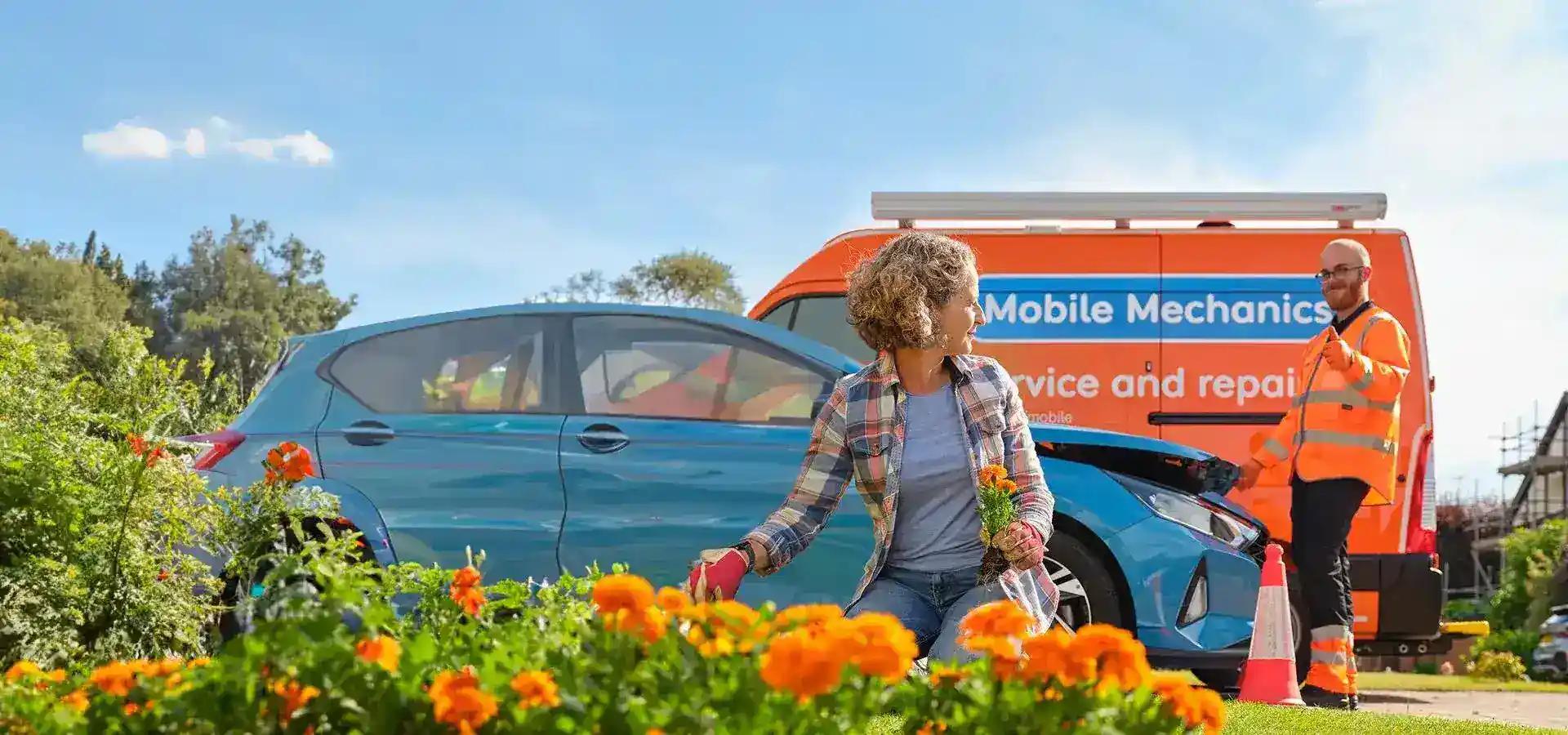 A close-up of a customer tending to her garden with an RAC Mobile Mechanic in the background.