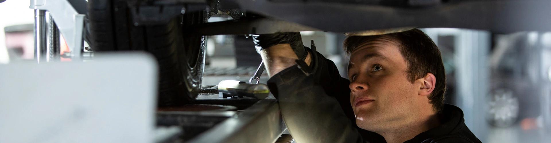 Mechanic working beneath a car