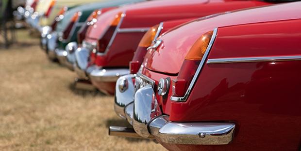 Close up of the back of a number of classic cars