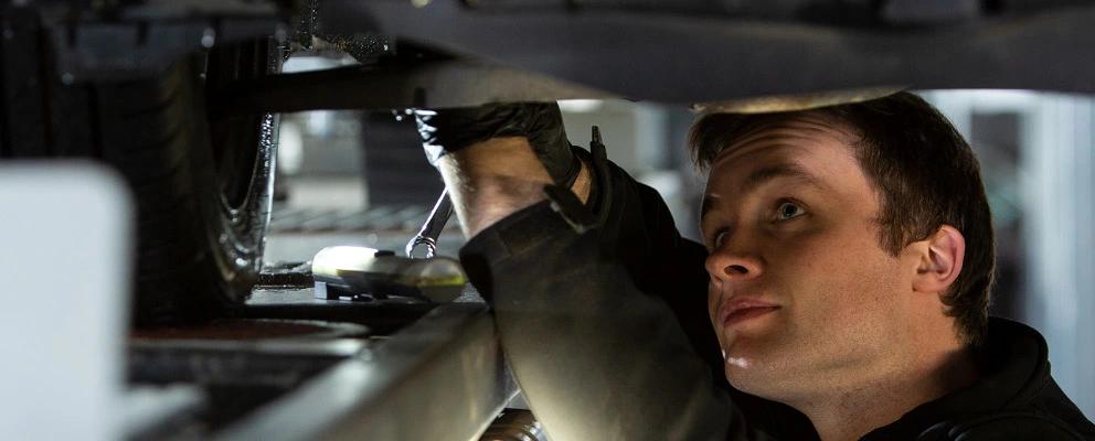 Mechanic working beneath a car