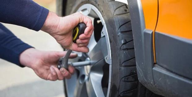 Close up of someone changing an alloy wheel