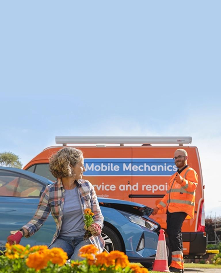 A customer in the garden with an RAC Mobile Mechanic in the background.