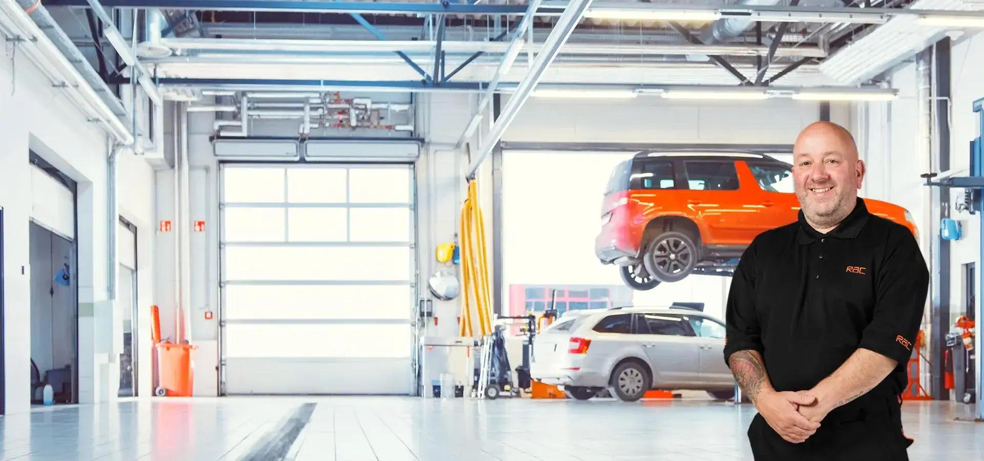 A picture of mechanic standing in an approved garage