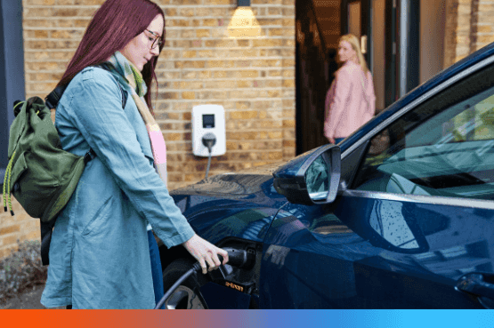 Young person plugging in their electric vehicle