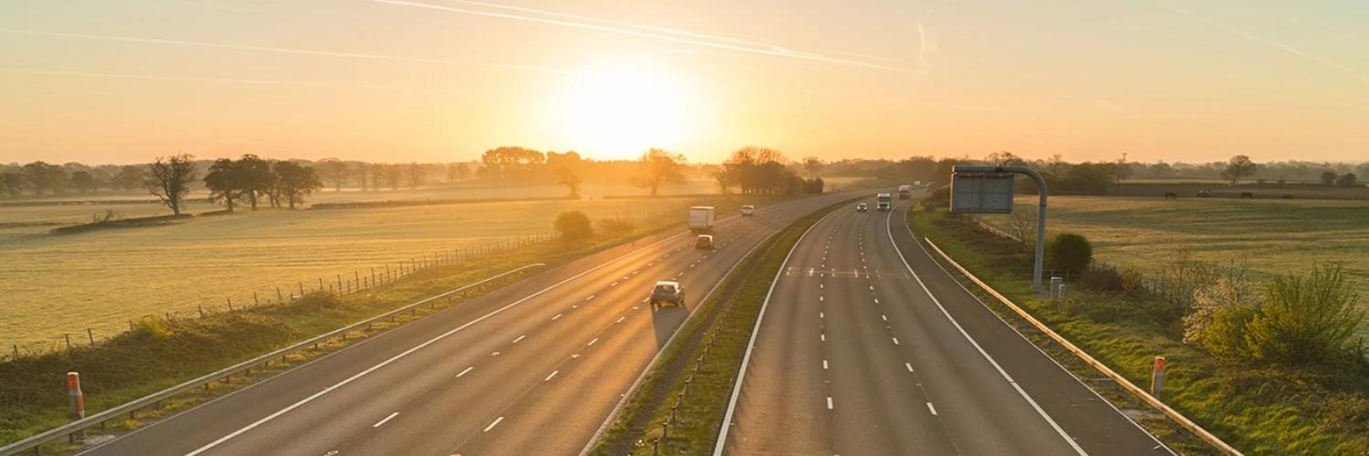 birds-eye photograph of motorway at sunset