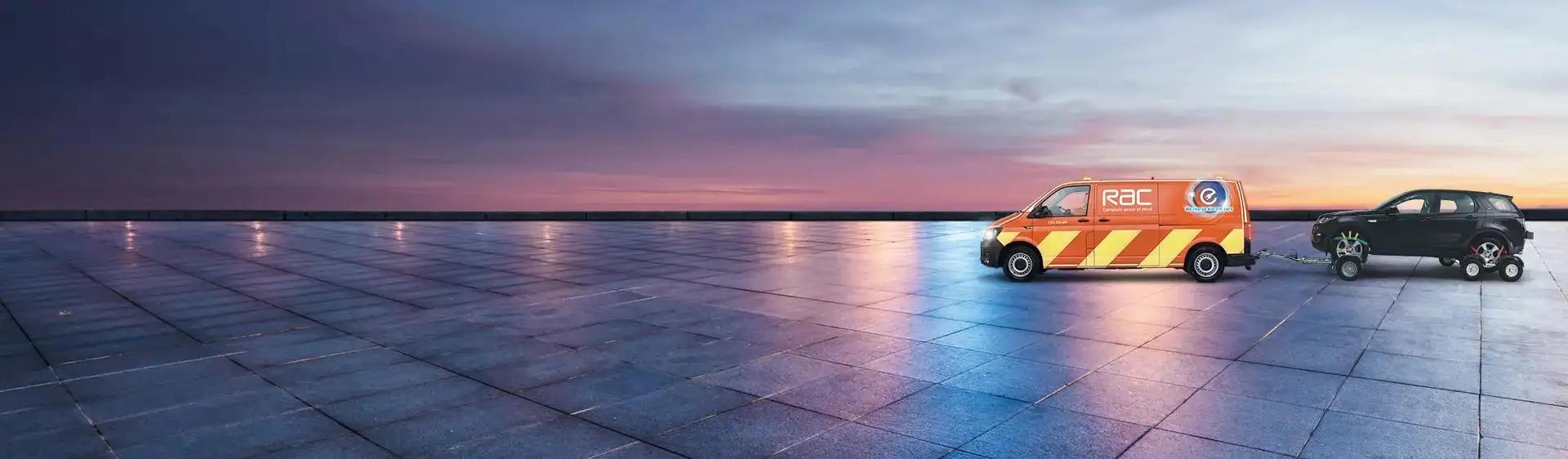 Patrol van towing a car on a rainy day