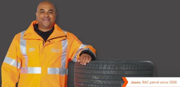 RAC patrol stood next door to a stack of tyres