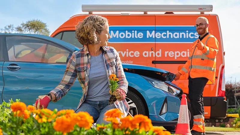 A customer tending to her garage with an RAC Mobile Mechanic in the background