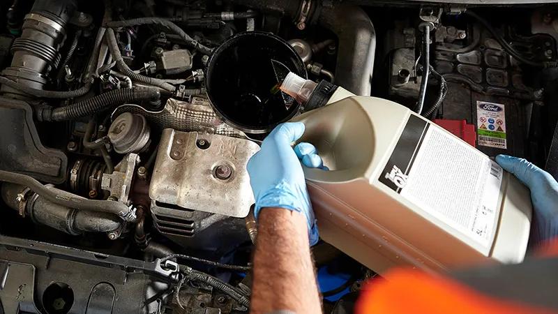 Close up of a car having its oil changed