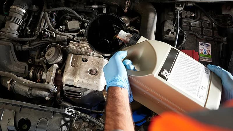 Close up of a car having its oil changed