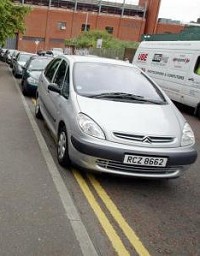 Car lifted to paint yellow lines