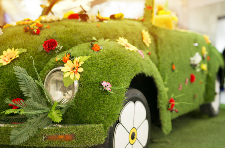 grass covered car with flowers