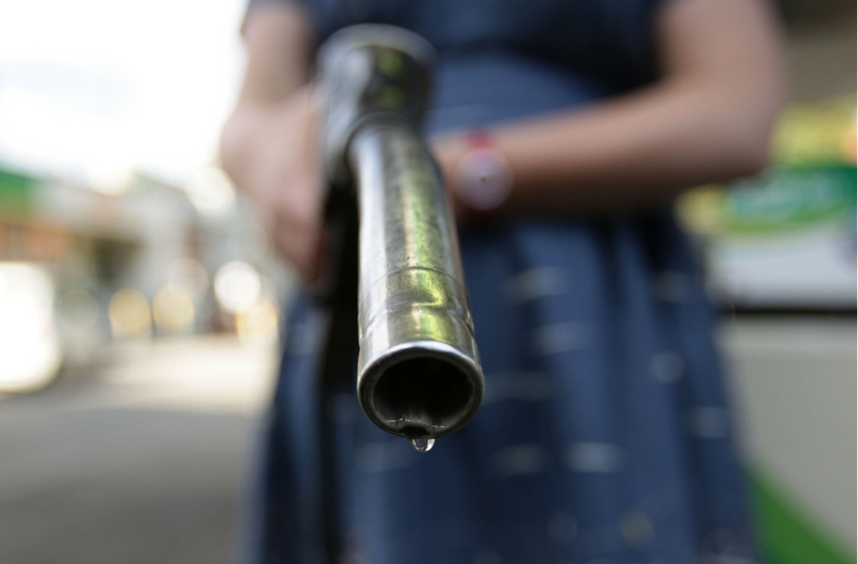 end of diesel pump with man holding it