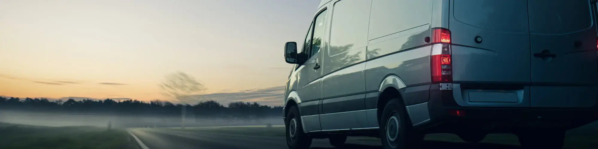 Van driving into sunset