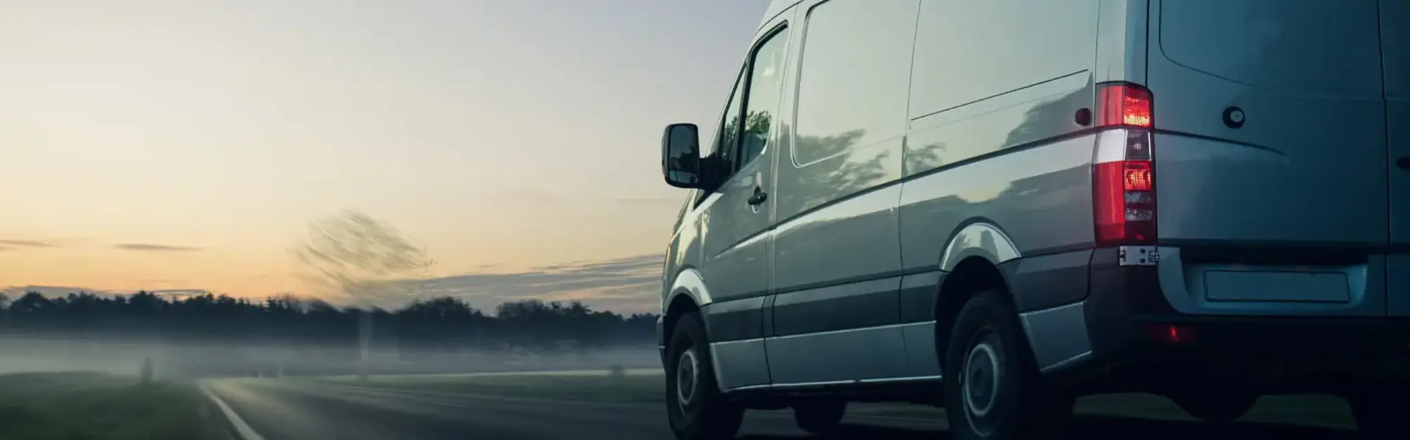 Van driving into sunset